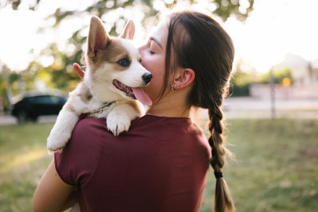 Woman holding corgi