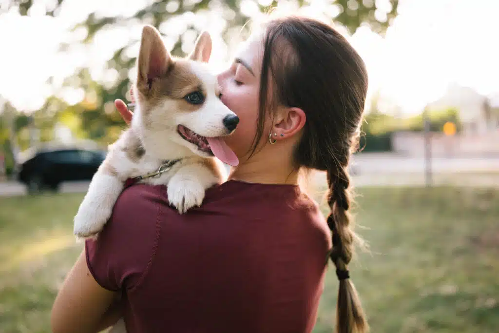 Woman holding corgi